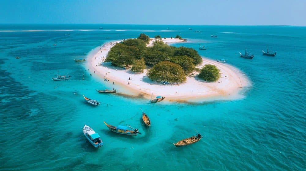 Aerial view of a turquoise lagoon and coral island in Lakshadweep